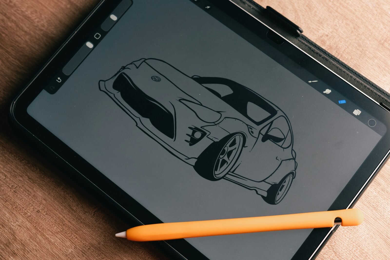 Black line drawing of a car on a tablet screen with a stylus resting beside it